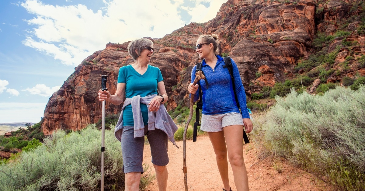 women hiking red rock canyon together