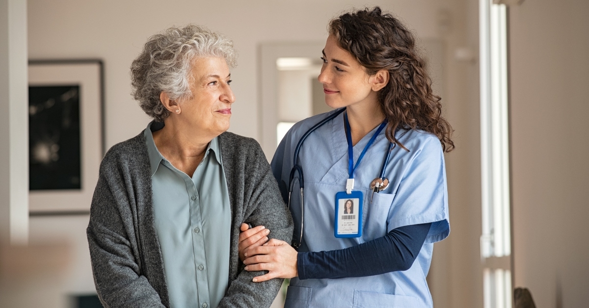 caregiver assists senior woman