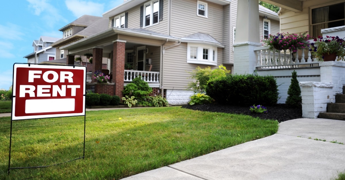for rent sign outside beautiful mansion