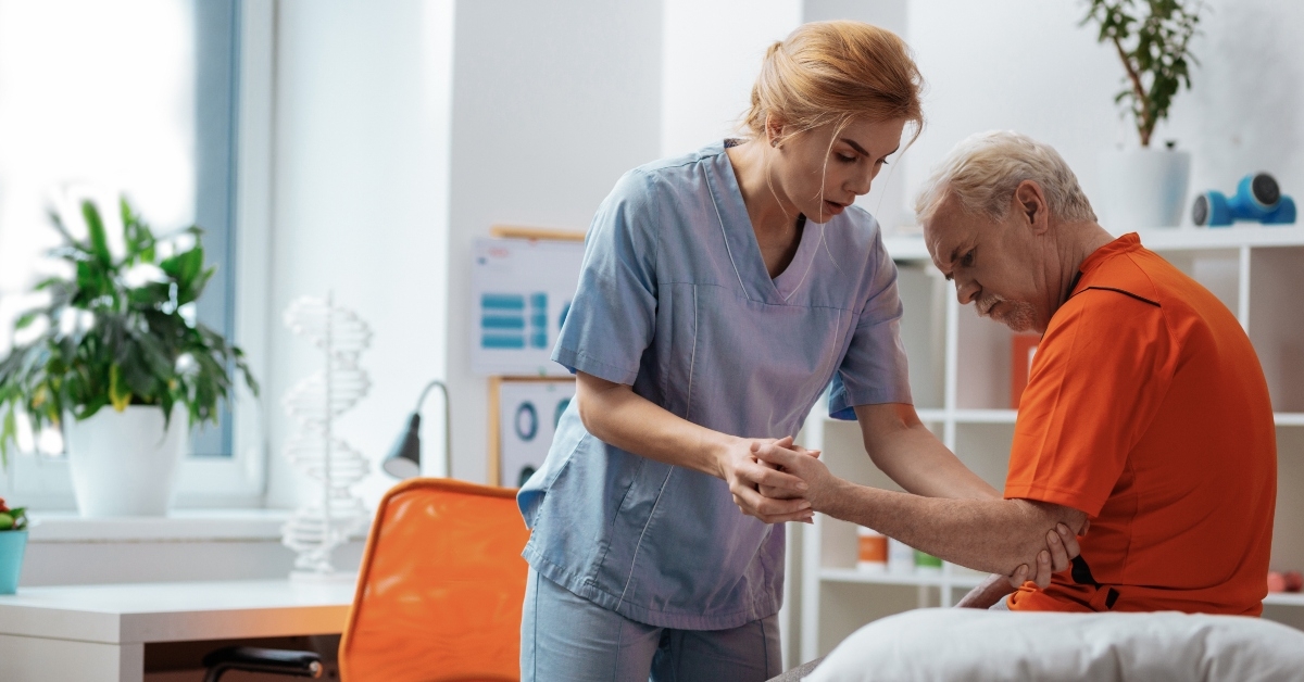nurse holding her patients hand