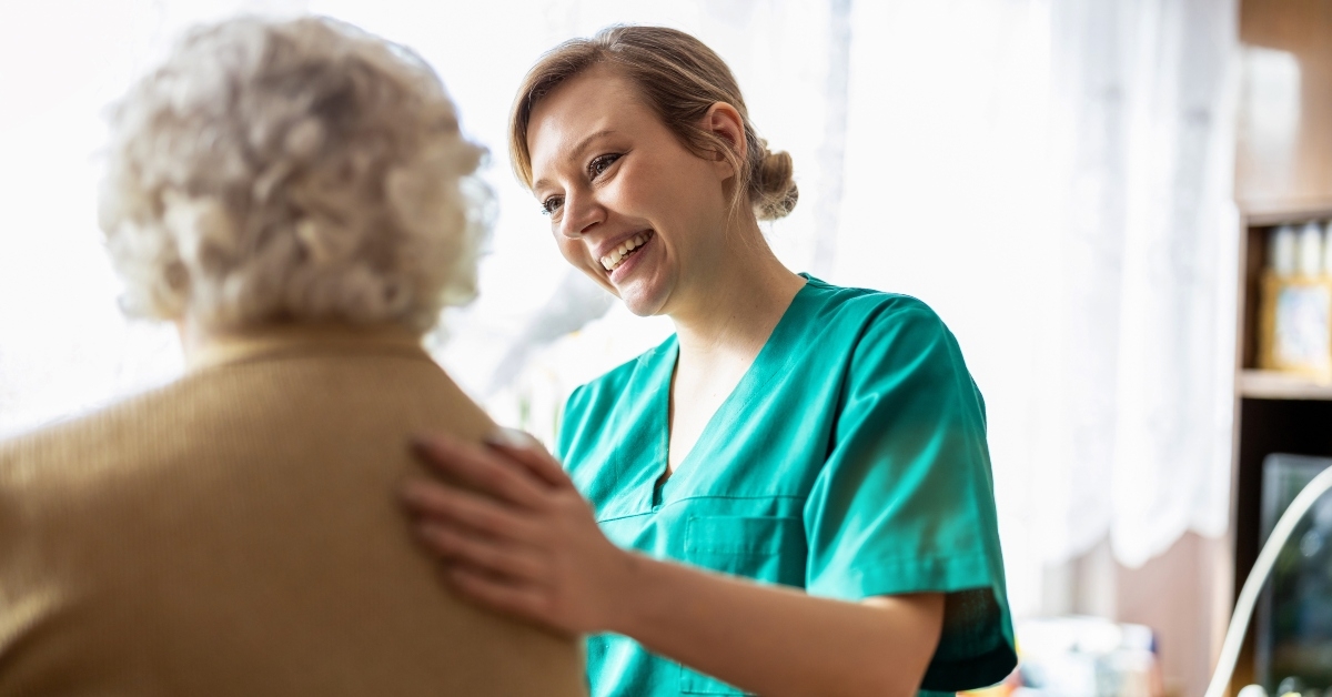 nurse supporting an elderly lady