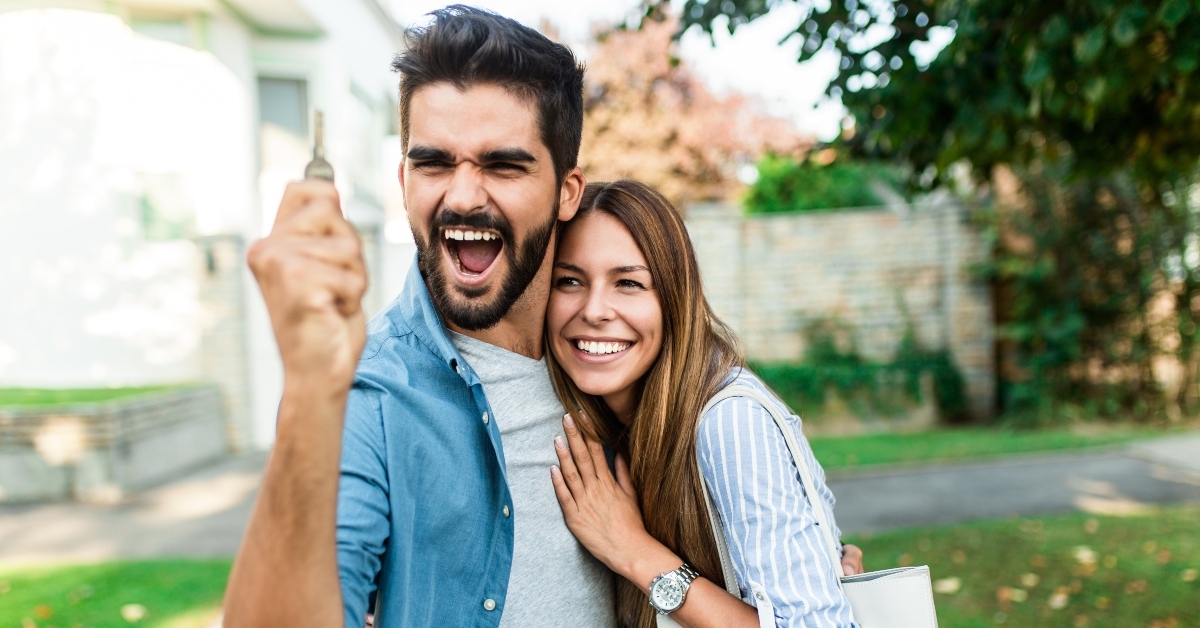 outside in front of their new home