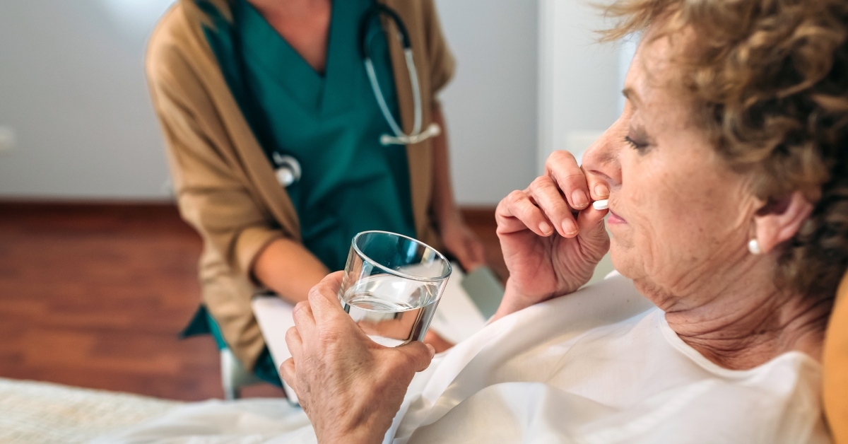 senior patient taking a pill