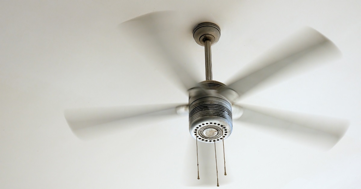 electric ceiling fan running inside room