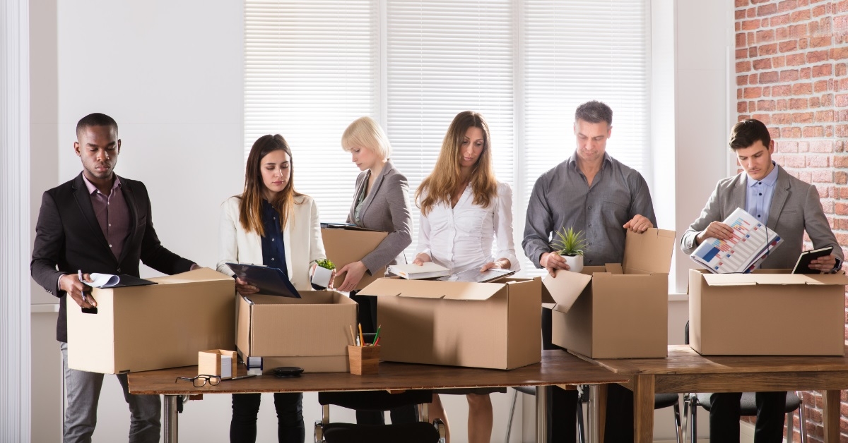 colleagues packing belongings after resigning
