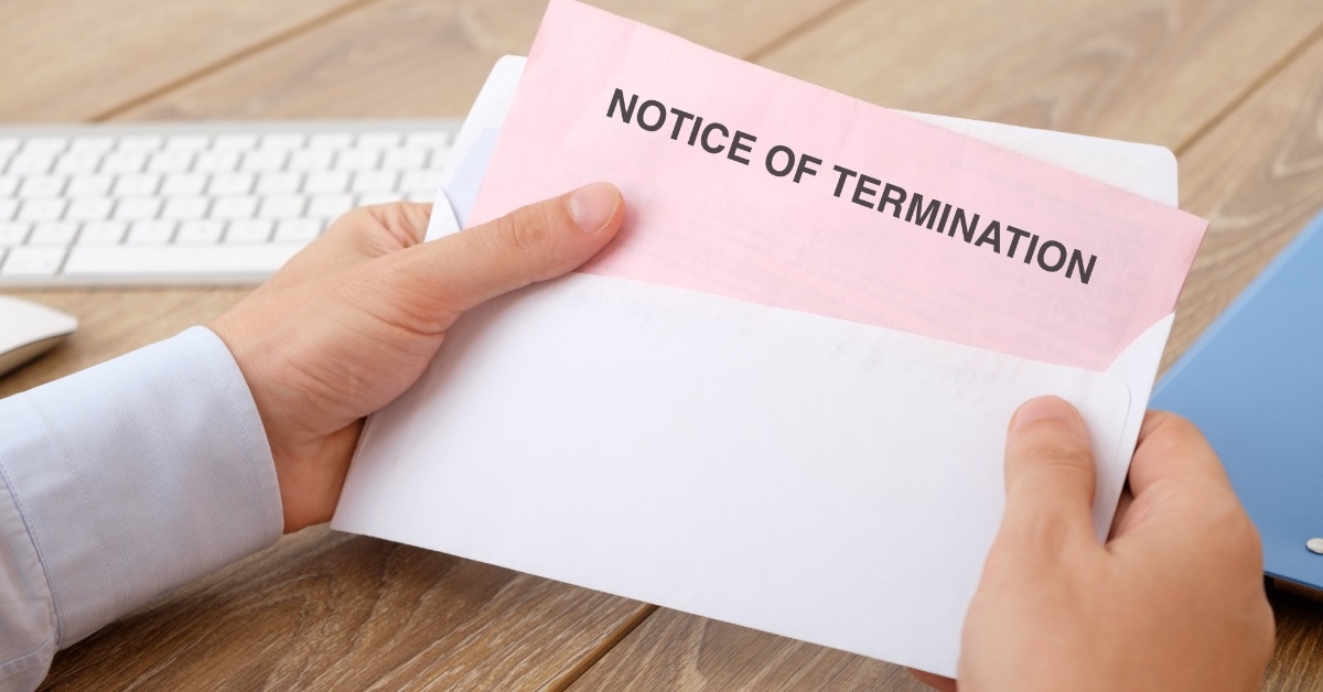 man holding notice of termination letter