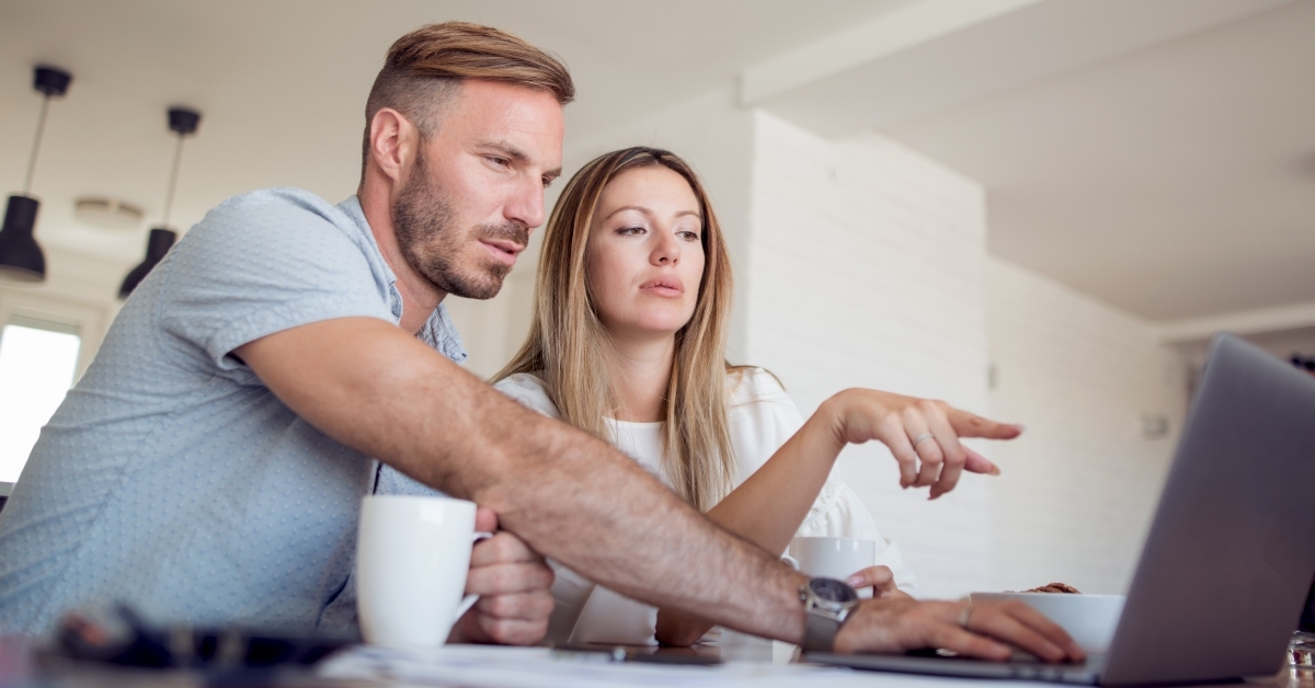 worried couple calculating budget