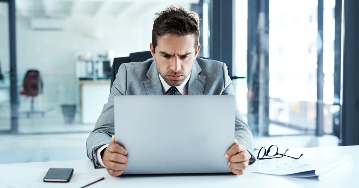 angry man on laptop in office