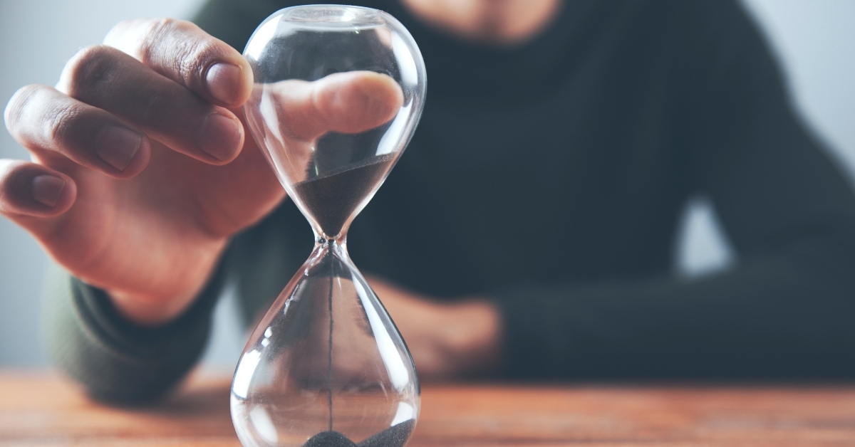 man holding sand clock