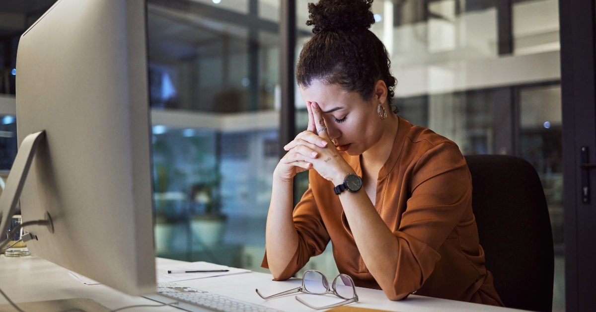woman with headache working in office