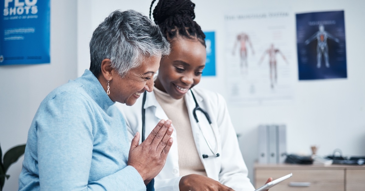 happy doctor and patient using tablet