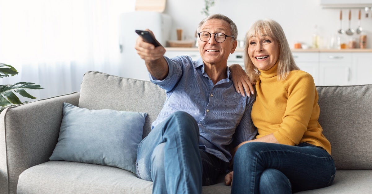 senior couple watching TV together 