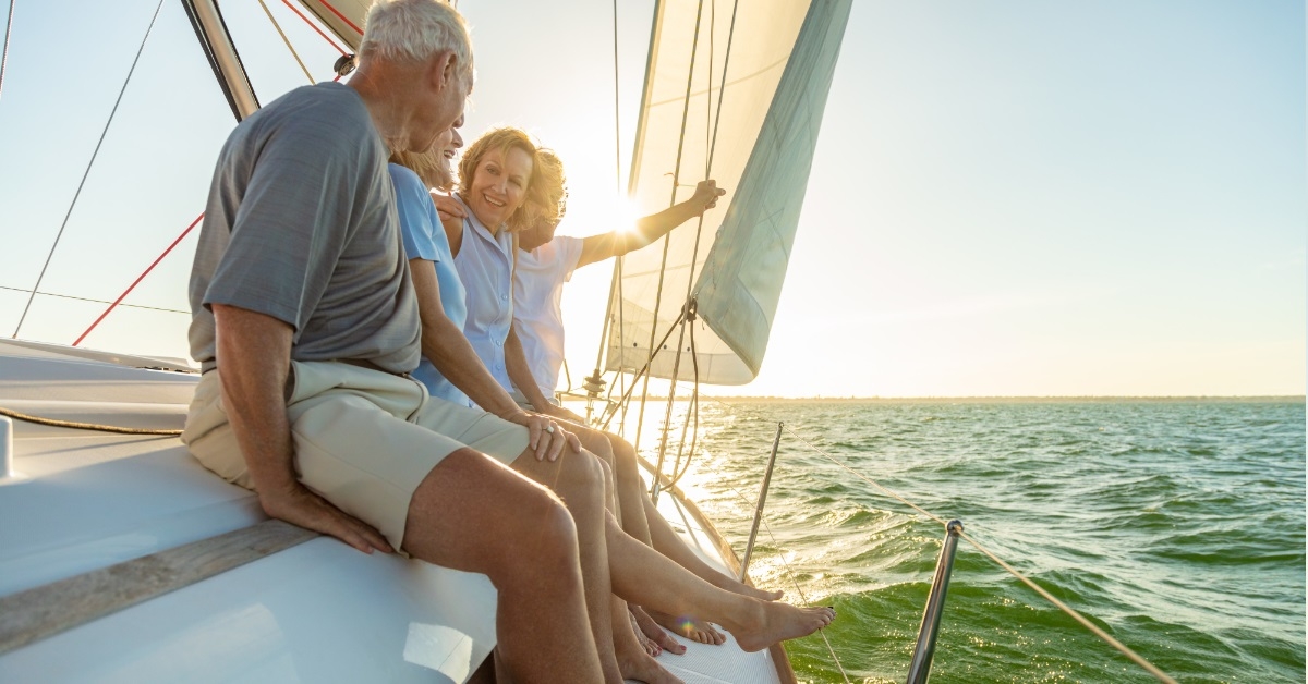 senior friends sailing on yacht
