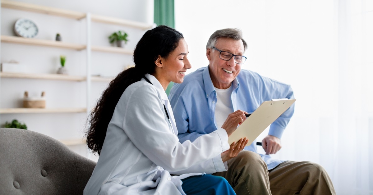 senior impaired man consulting female doctor