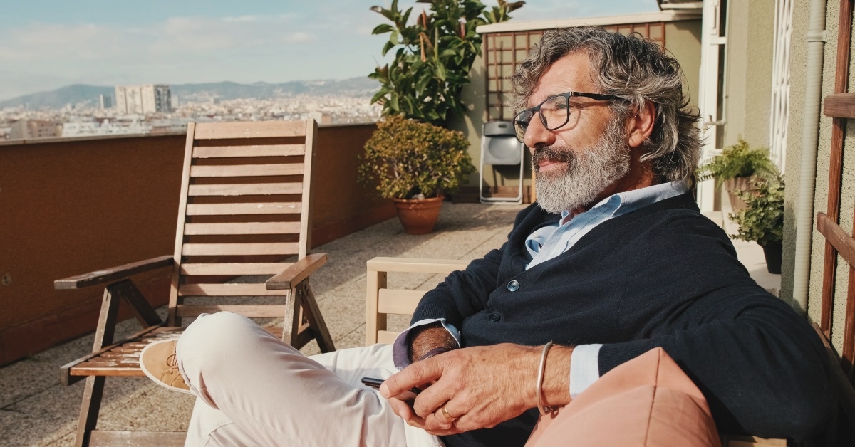 attractive man enjoying sun in balcony