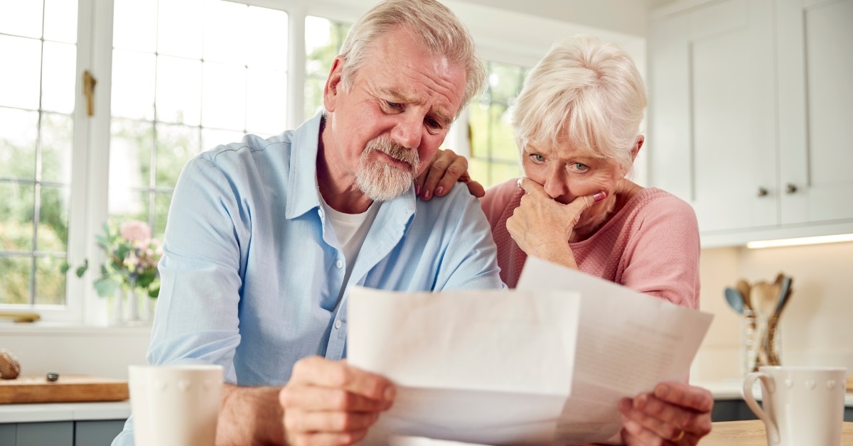 stressed senior couple reviewing bills
