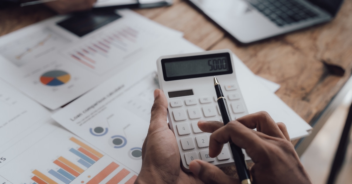 accountant reviewing budget using calculator