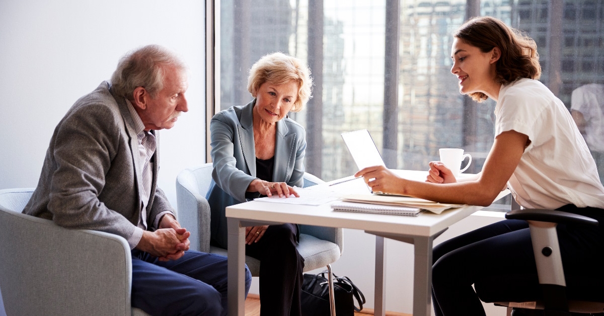 senior couple meeting female finance advisor