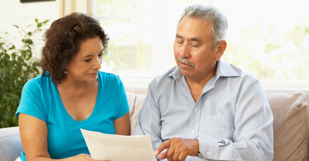 senior couple reviewing documents at home