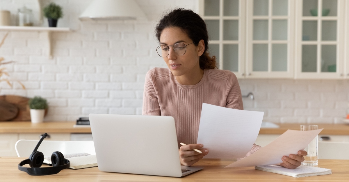 hispanic woman holds financial documents