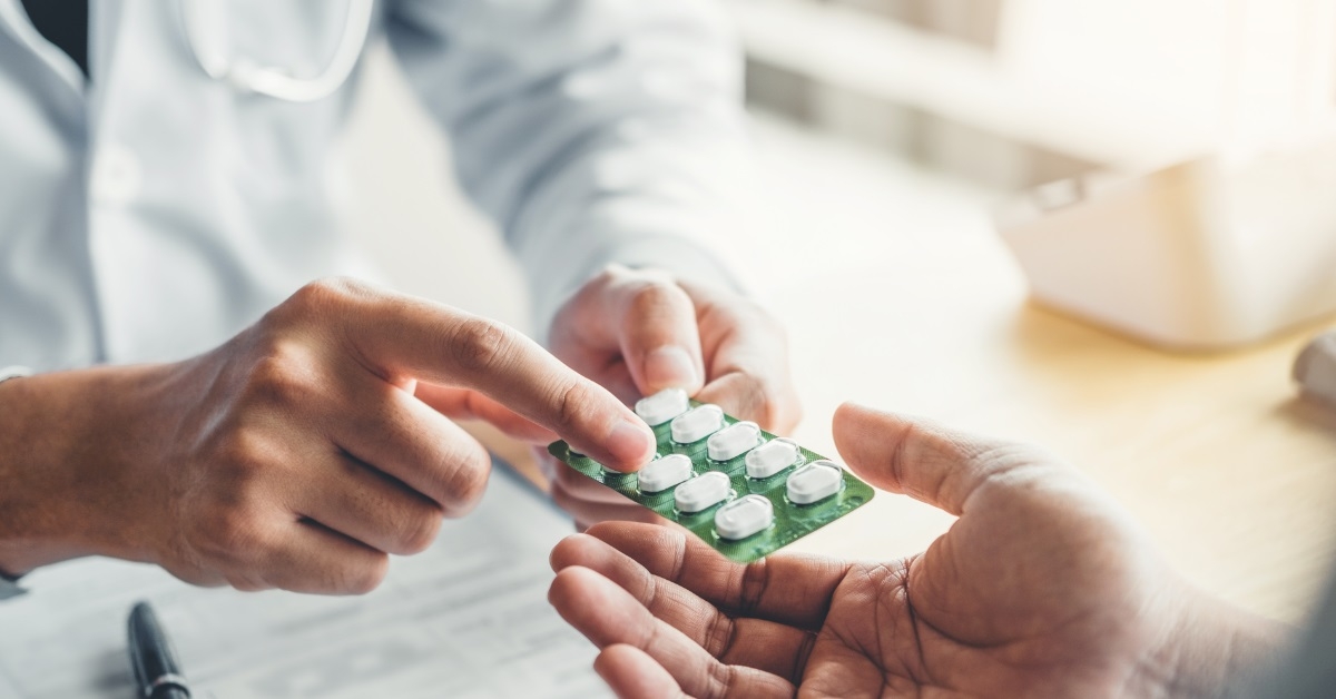 physician recommending pills to patient