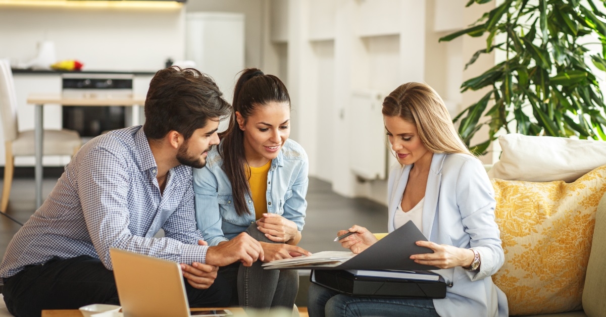 couple consulting female real estate advisor