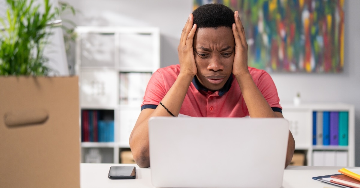 stressed african american man grabbing head