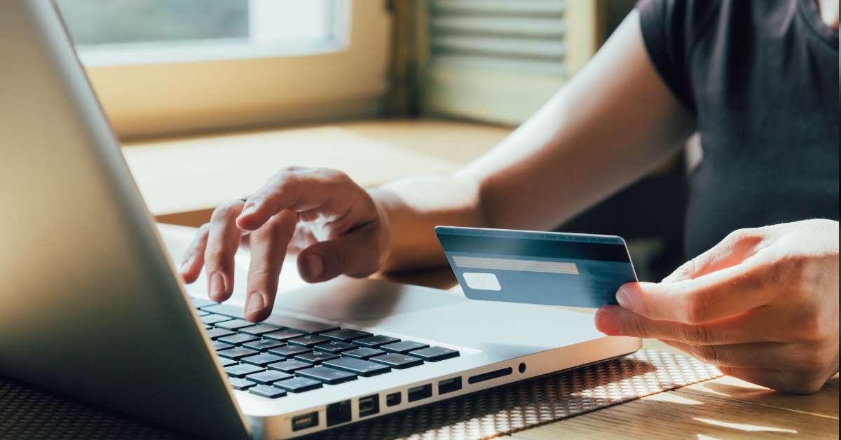 girl shopping on laptop using card