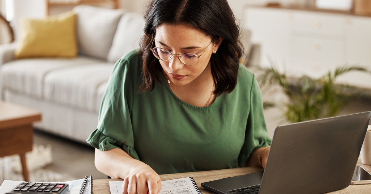 woman reviewing monthly budget at home