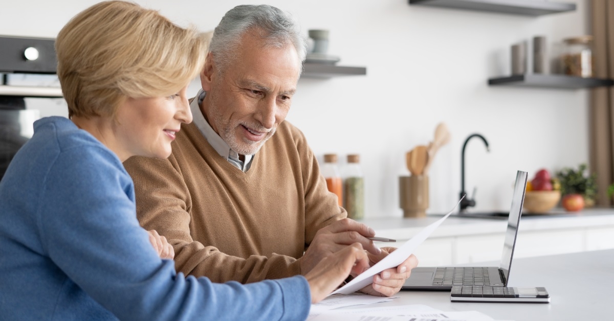 couple reviewing bills at home kitchen