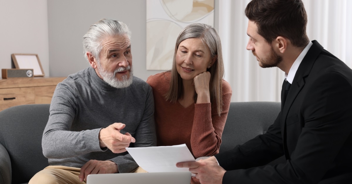 senior couple consulting male insurance agent