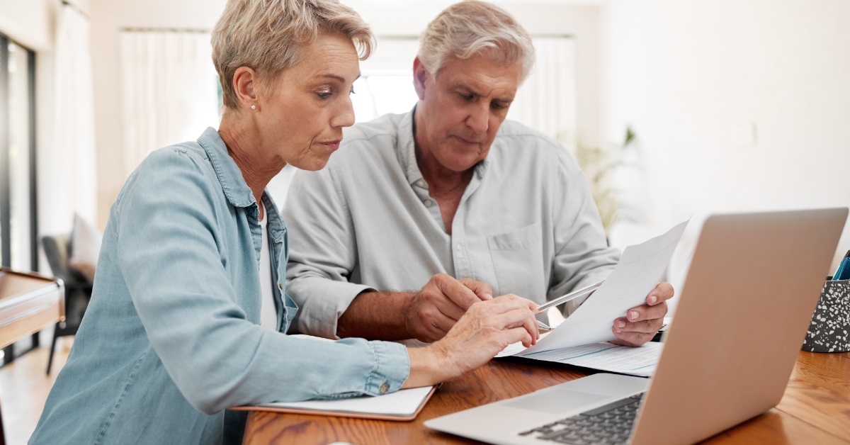senior couple reviewing mortgage bill together