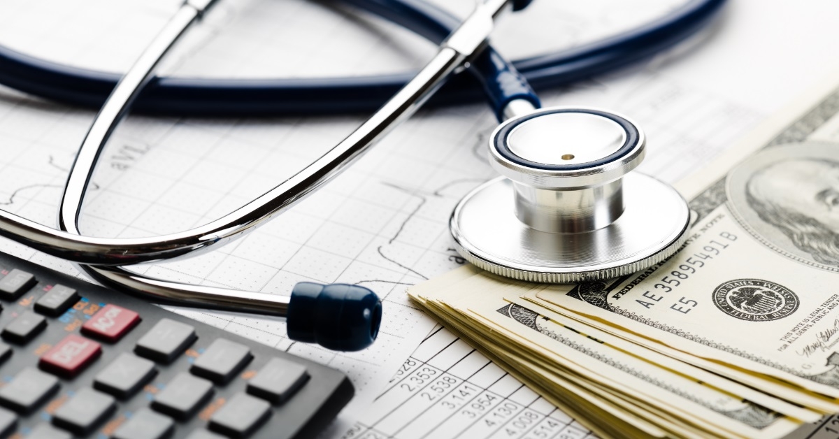 stethoscope on banknotes healthcare cost concept