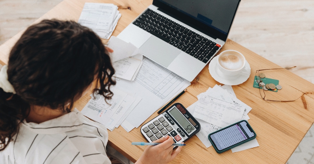 A female is calculating data with calculator.