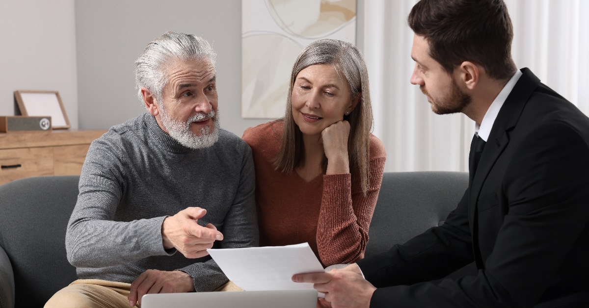 Insurance agent advising couple about pension plan.