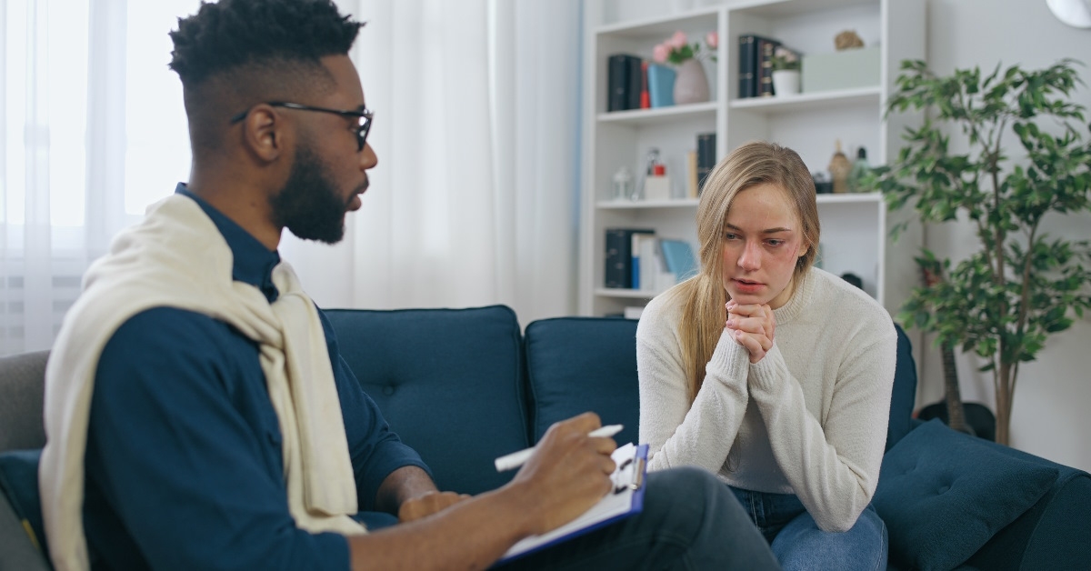 Psychiatrist talking with victum of domestic violence. 