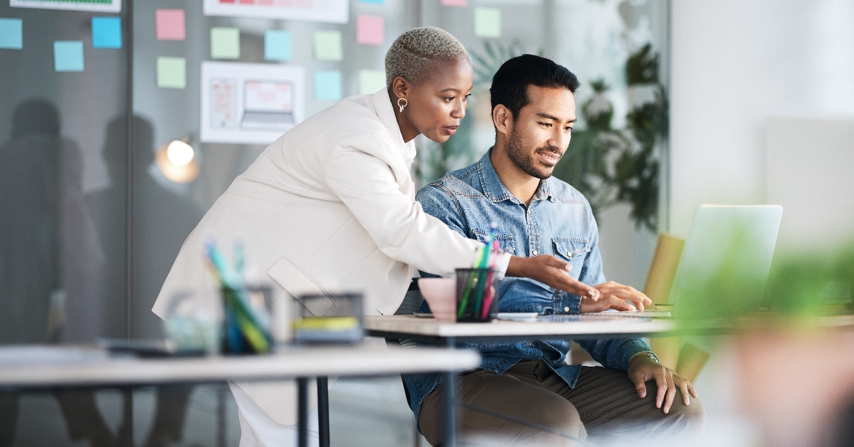 The staff mentor is providing guidance to team designer.