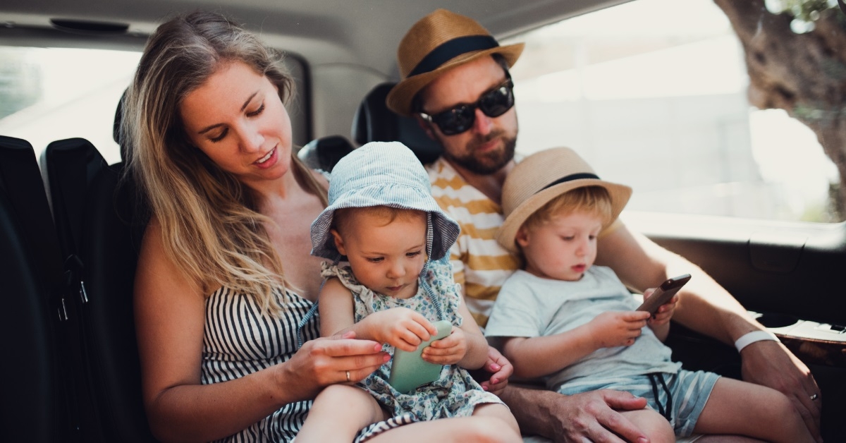 family traveling in taxi on vacation
