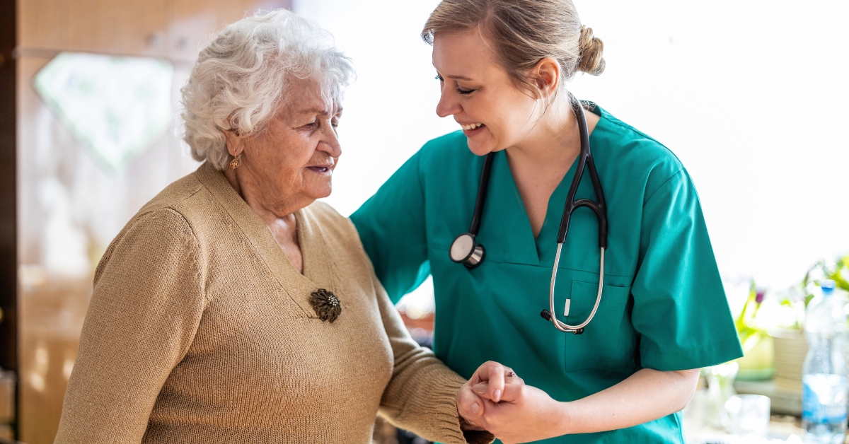 nurse supporting an elderly lady