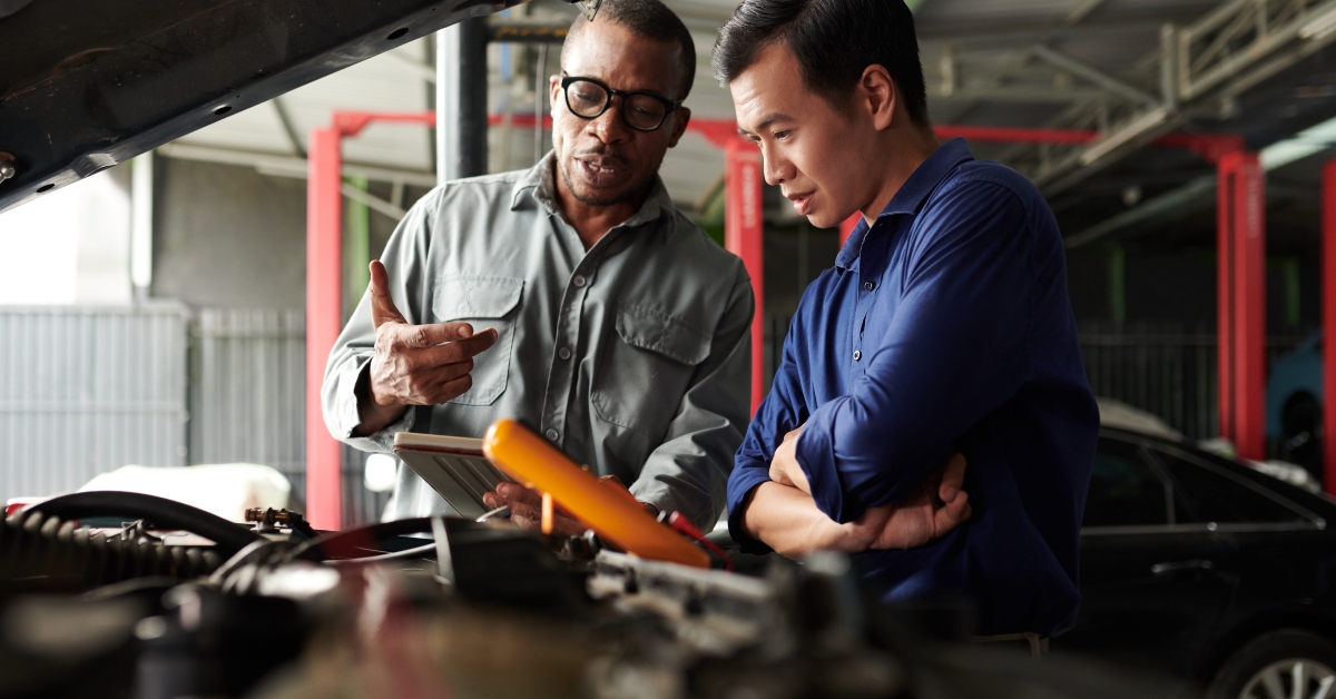 car mechanic talking to owner
