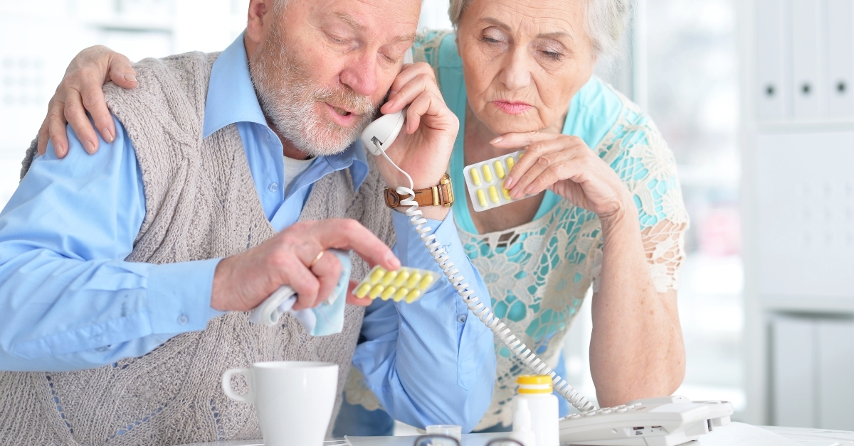 elderly couple with pills
