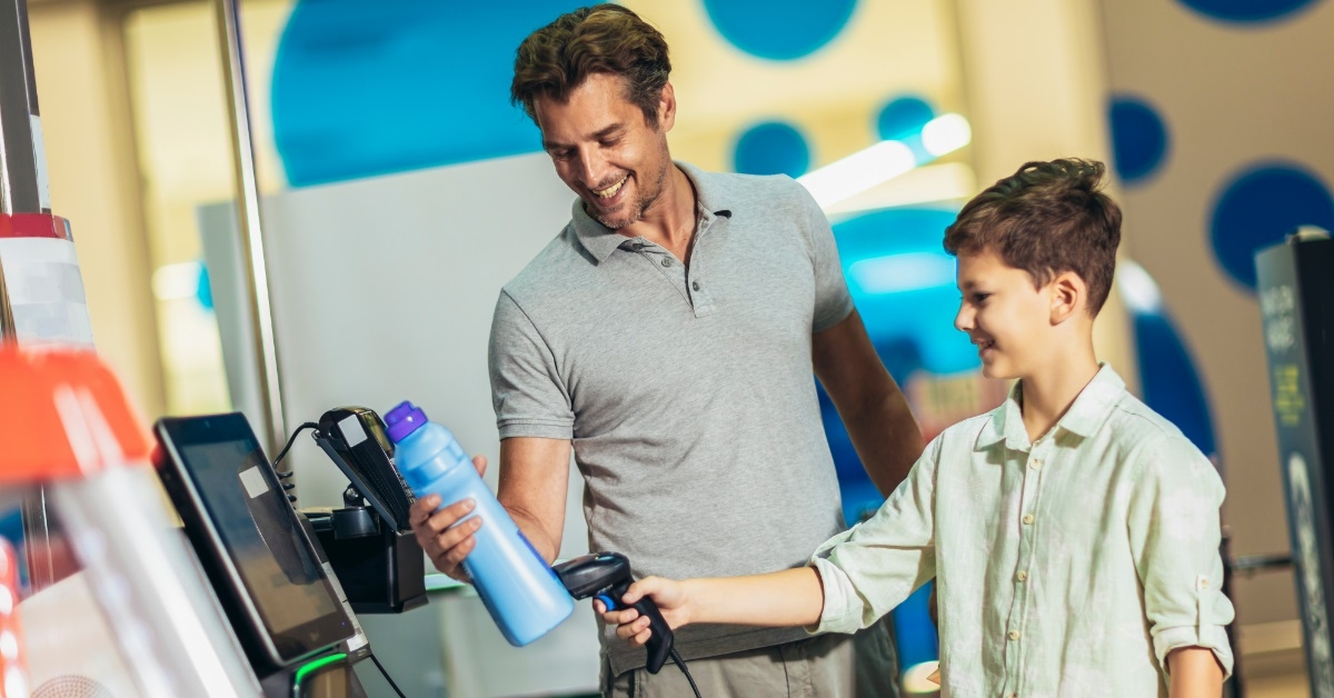 father and son at self checkout