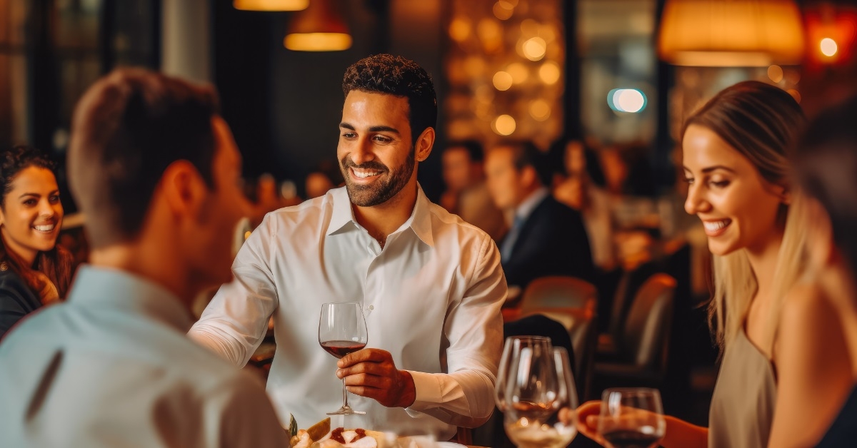 happy friends eating dinner in restaurant