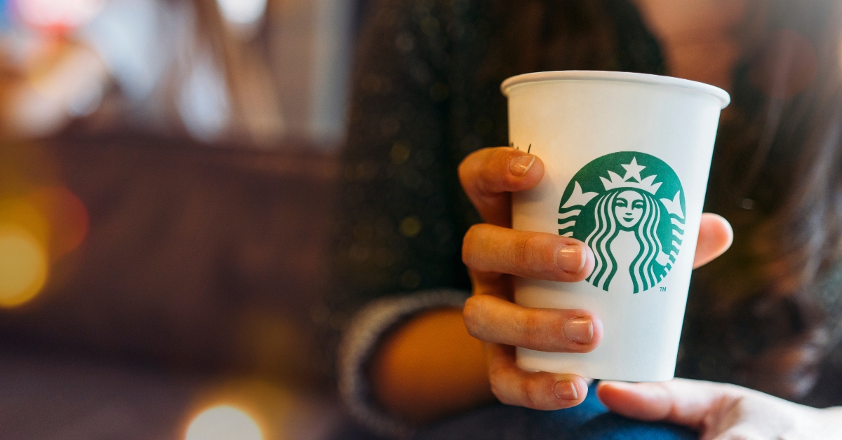 woman drinking a tall starbucks coffee