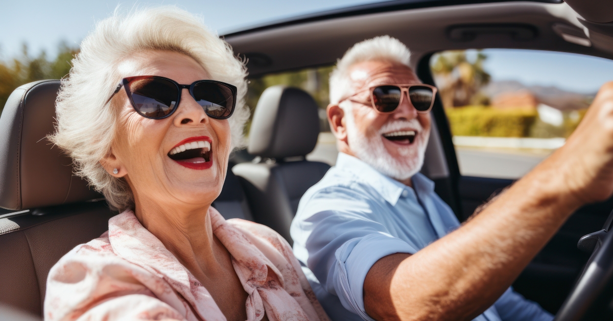 senior couple traveling in their car