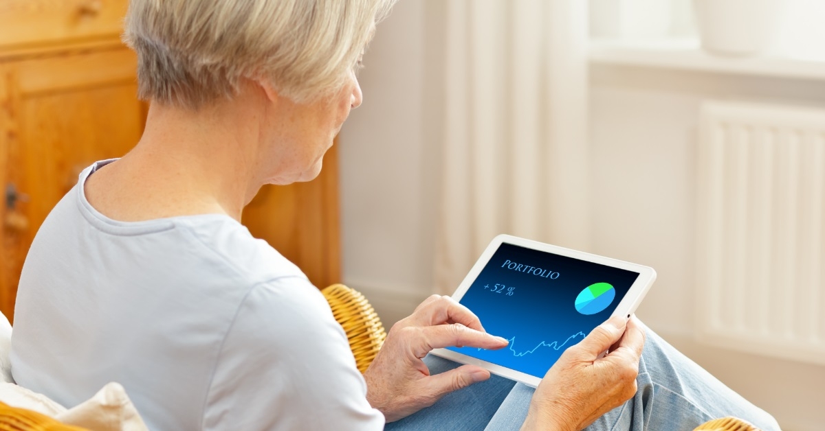 woman checking investment portfolio on tablet