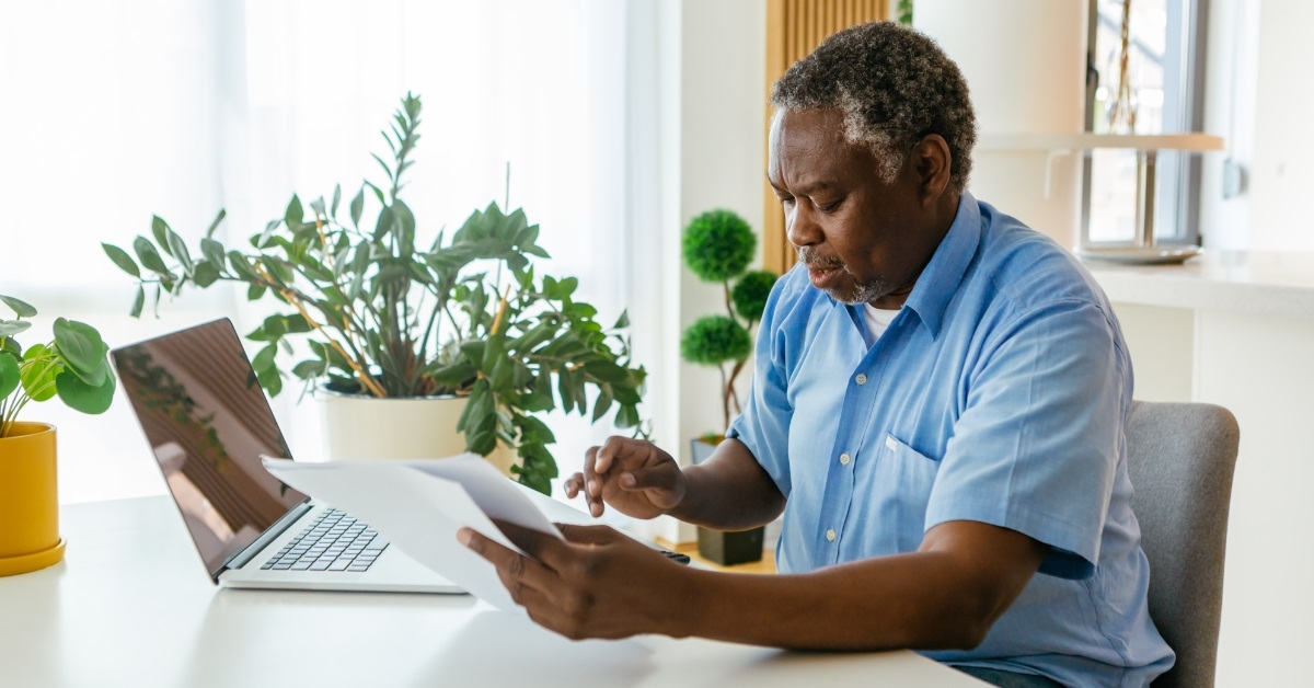 stressed african american man reviewing documents