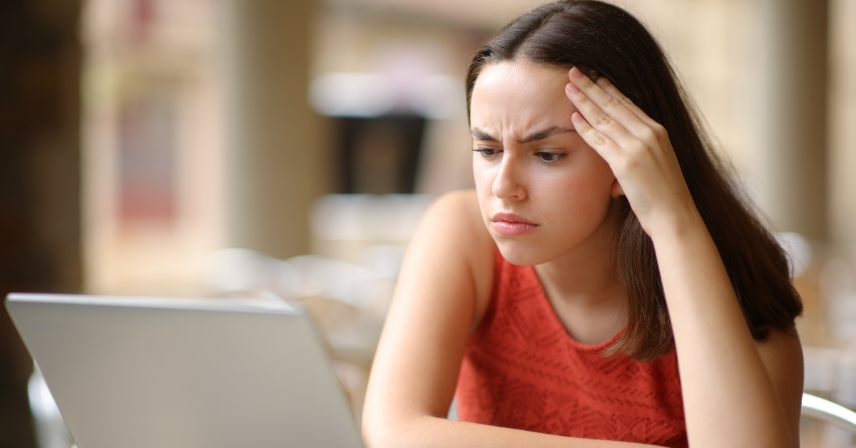 worried woman checking laptop content
