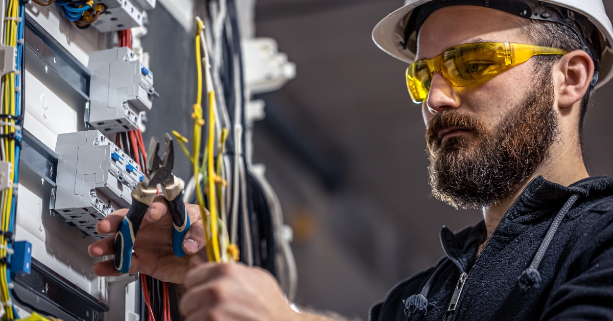 electrician works in a switchboard
