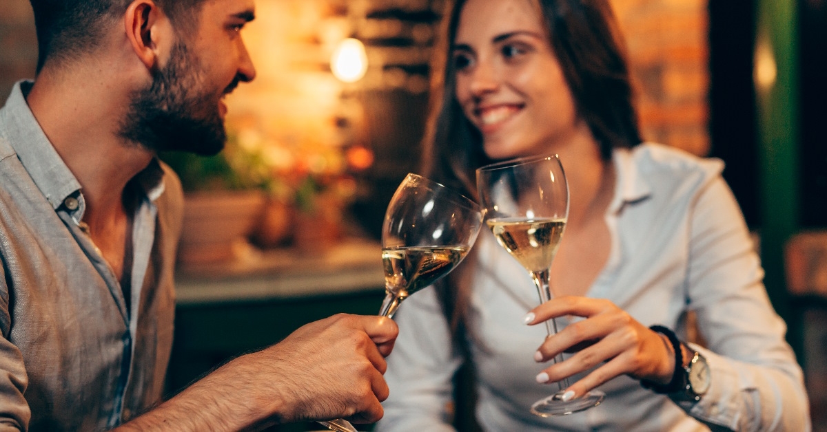 couple toasting wine at dinner